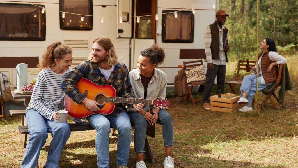 friends camping with rv and guitar