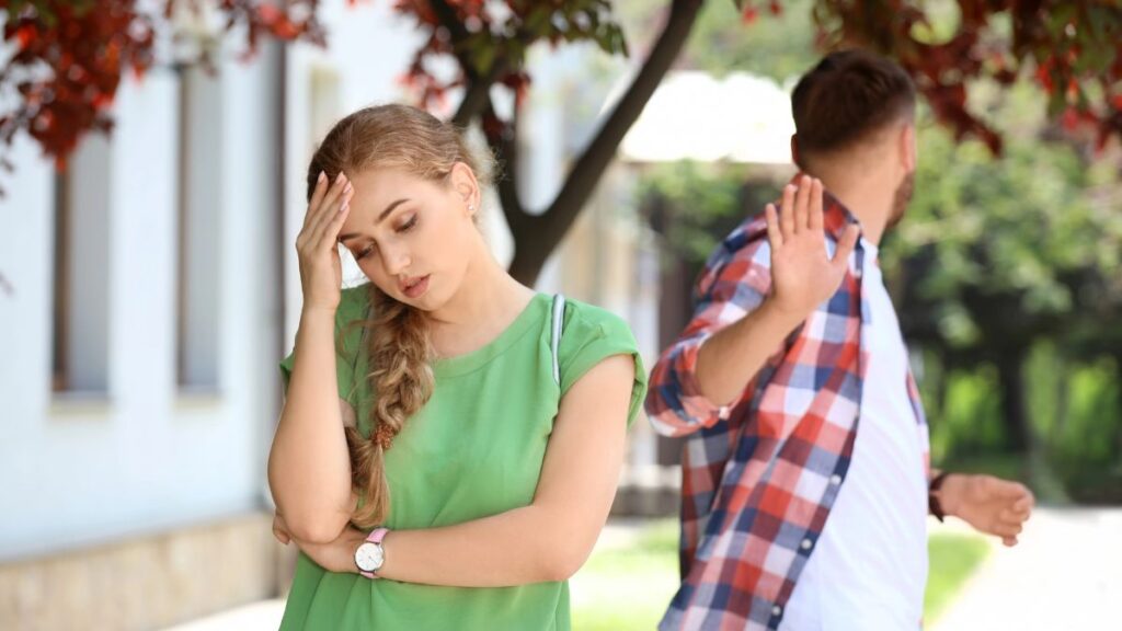 frustrated couple looking away outside