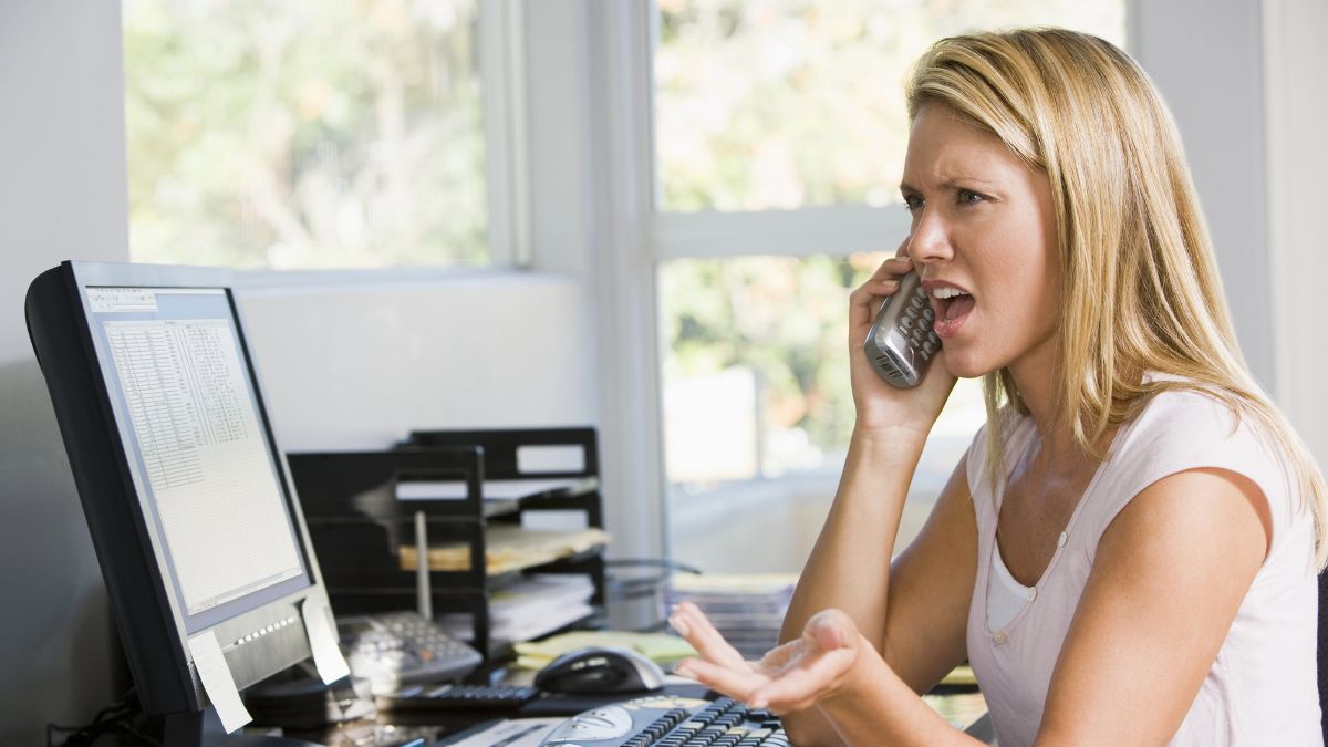 frustrated woman on computer and phone