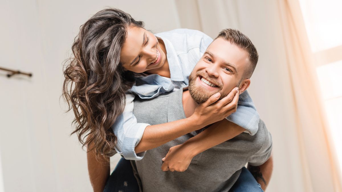 happy couple woman on mans back