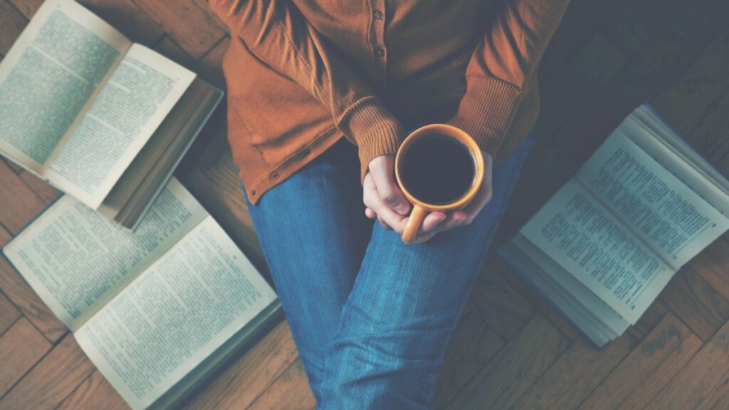 holding a cup of coffee