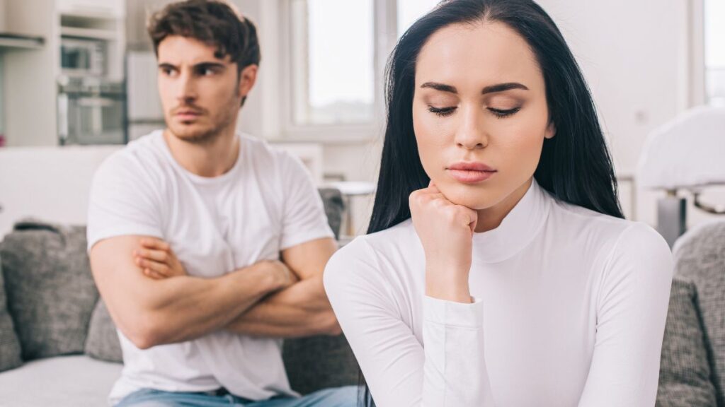 irritated couple looking away on couch