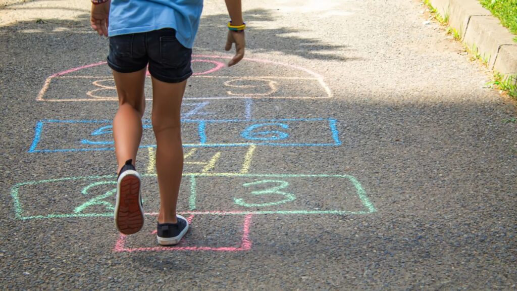 kid playing hopscotch