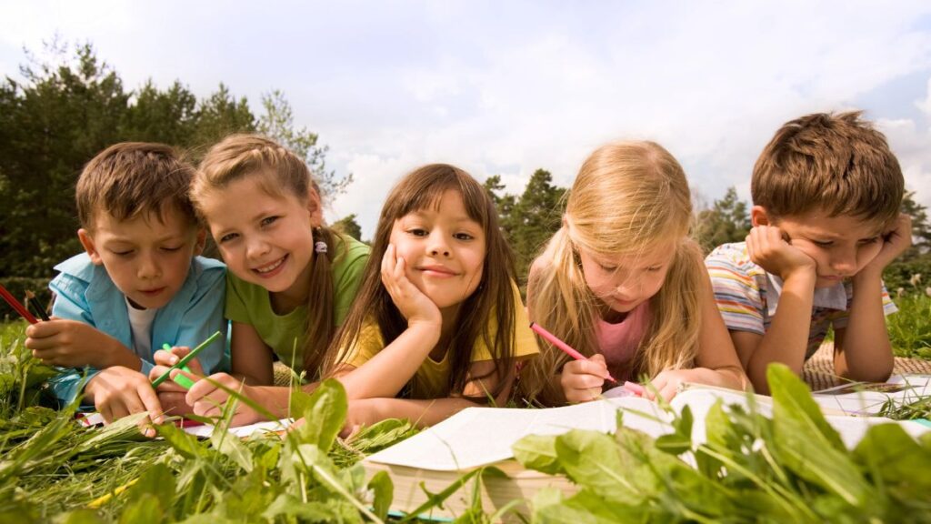 kids coloring on grass