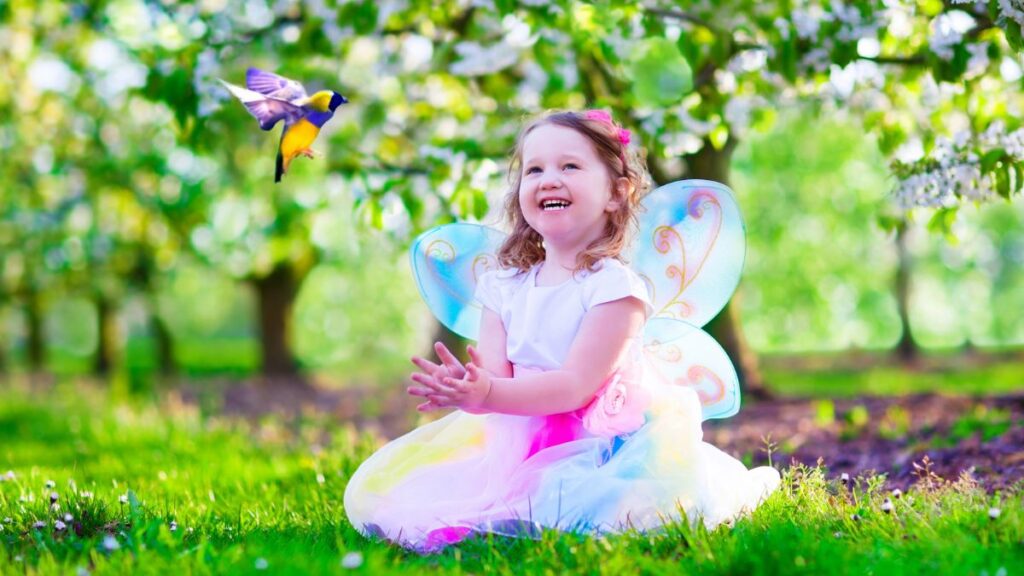 little girl in fairy costume outside