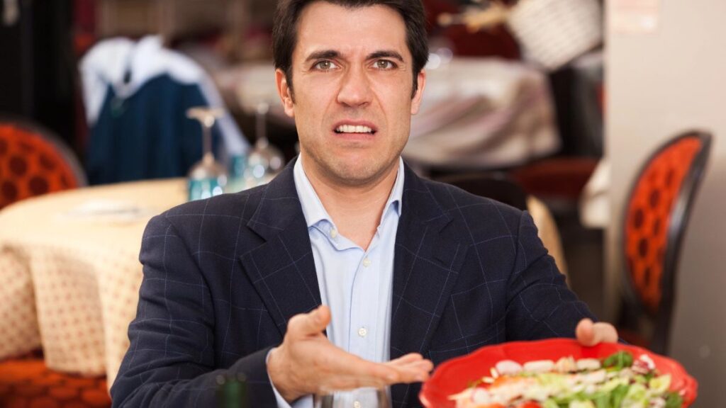 man disgusted with salad