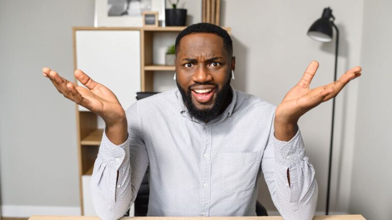 man looking shocked at desk