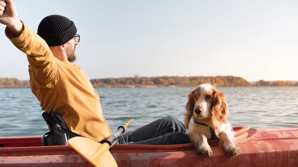 man on canoe with dog