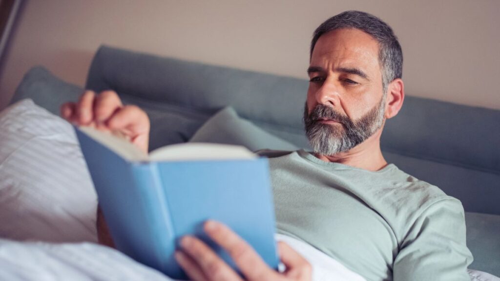 man reading in bed