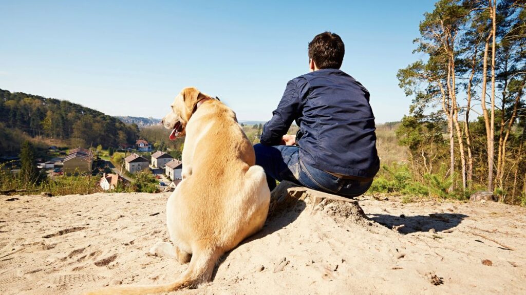 man sitting with dog 