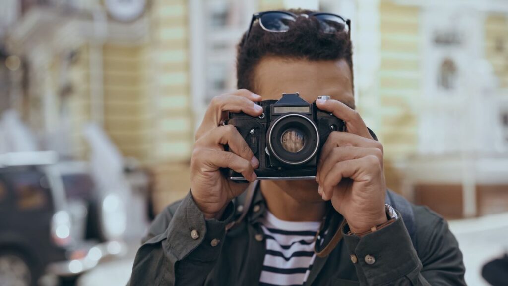 man taking pictures with camera