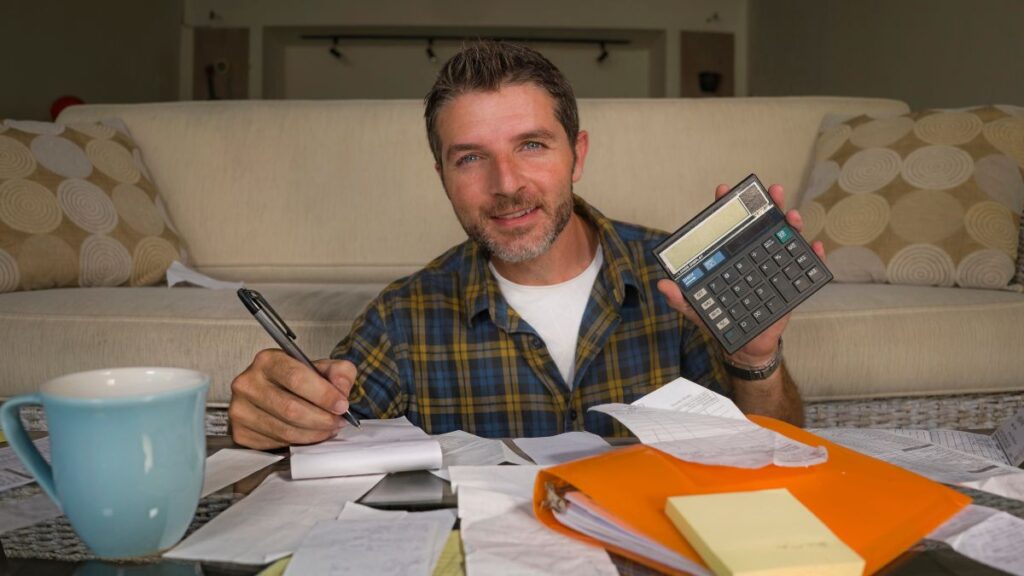 man with bills and calculator