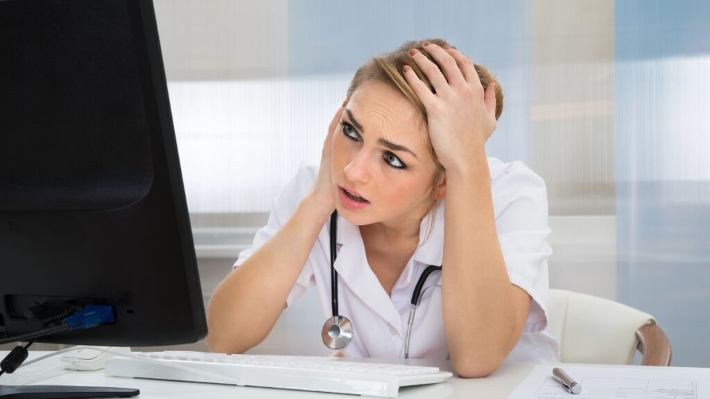 nurse stressed at computer