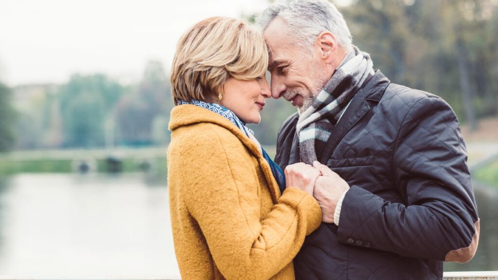 older couple holding hands outside