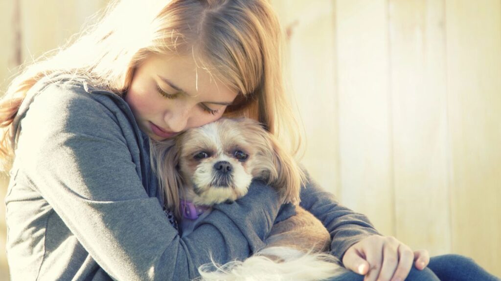 sad girl hugging dog