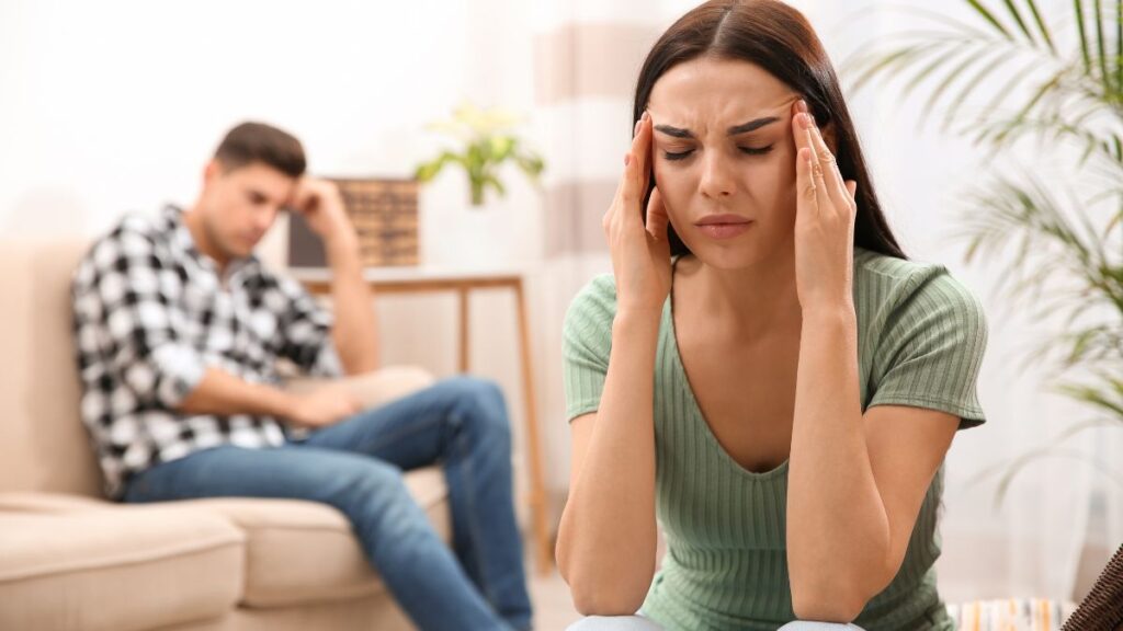 stressed couple sitting apart