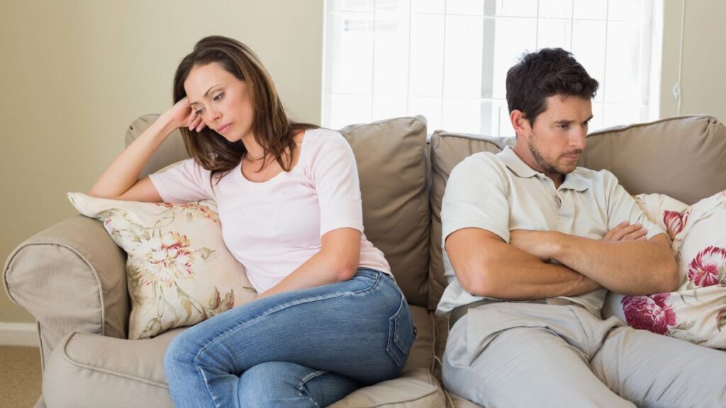 unhappy couple facing