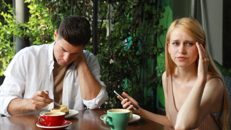 unhappy couple sitting at table