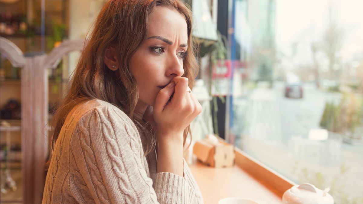 upset woman looking out window