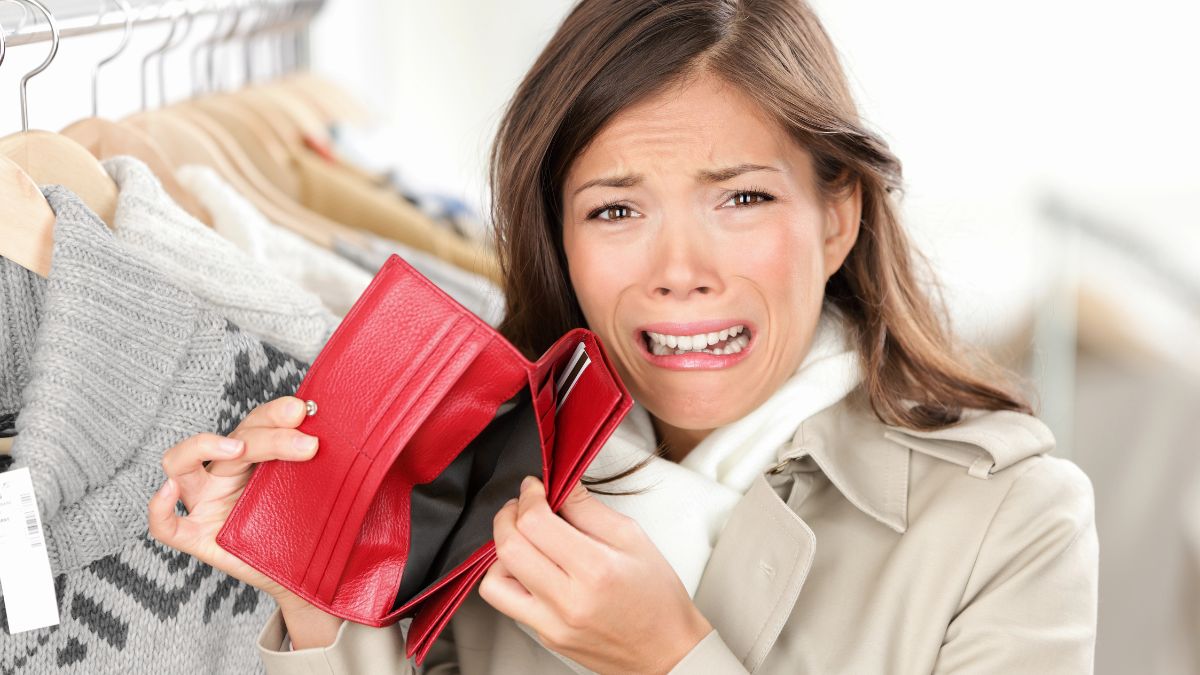 upset woman with empty wallet