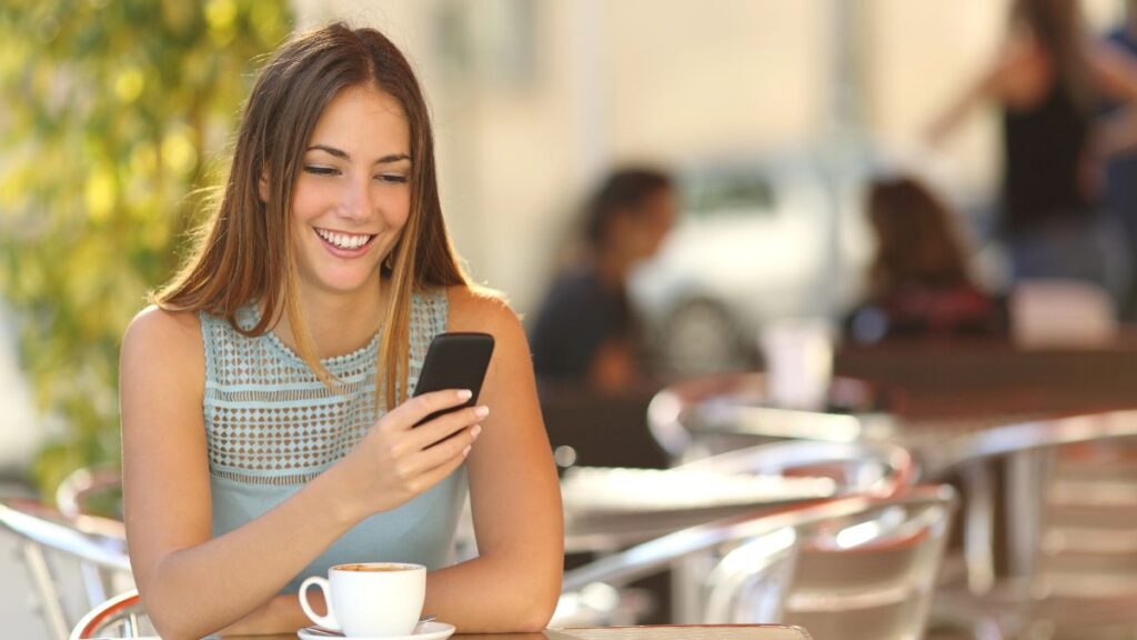 woman at table on phone