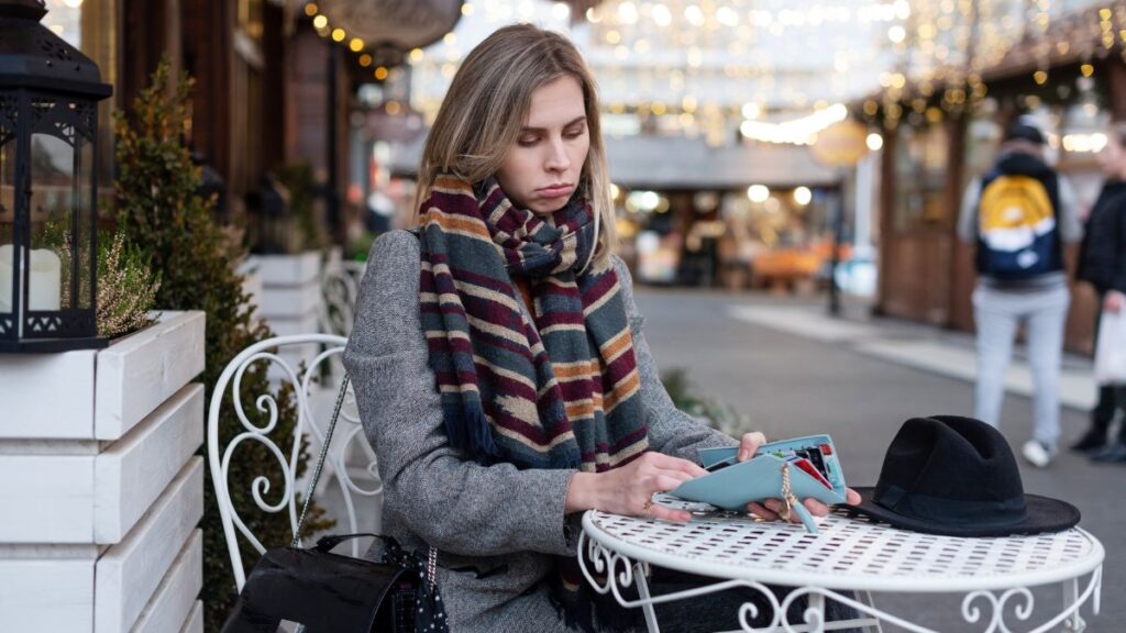 woman at table with wallet