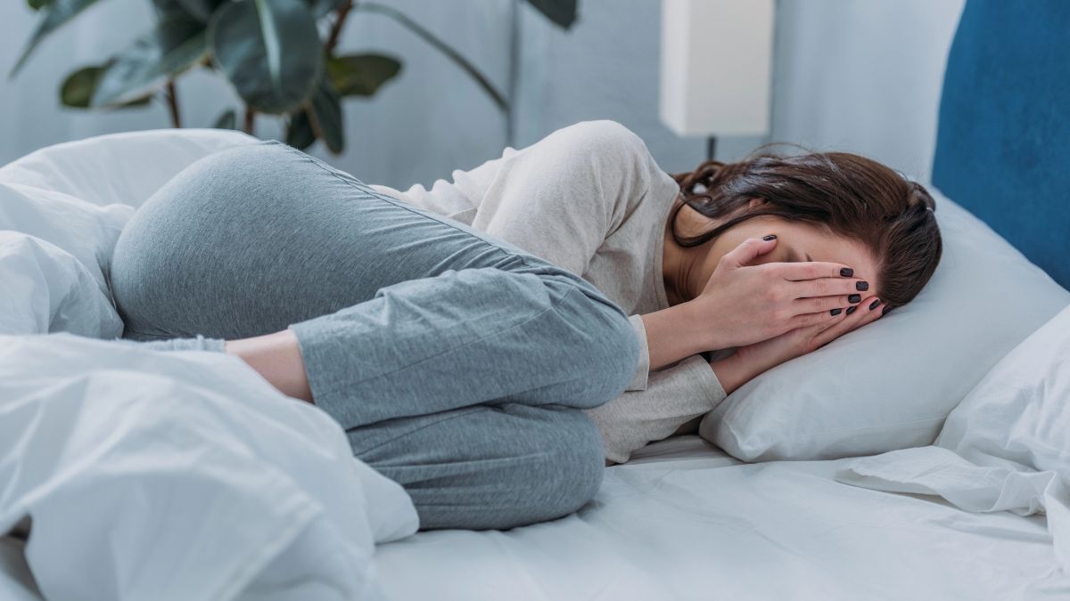 woman crying in bed