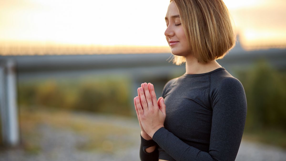 woman doing meditation at the beach