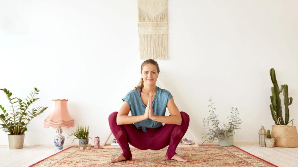 woman doing yoga squat woman in tree pose