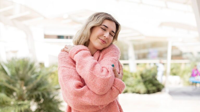 woman giving self hug