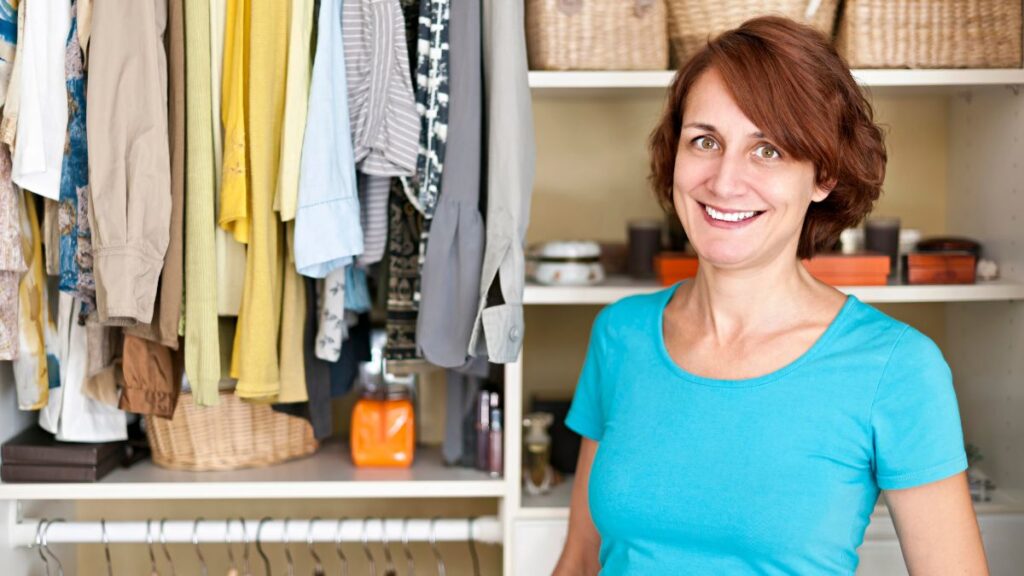 woman in closet with built in shelves