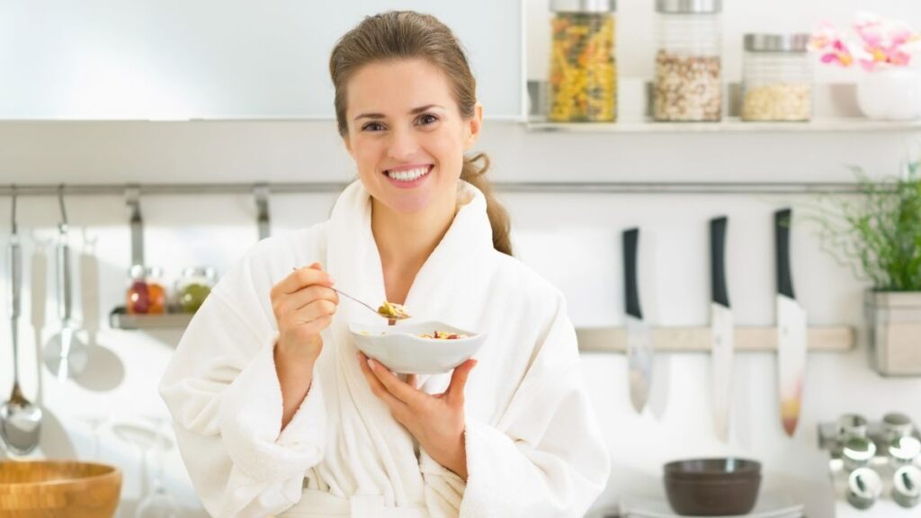 woman in rob eating breakfast