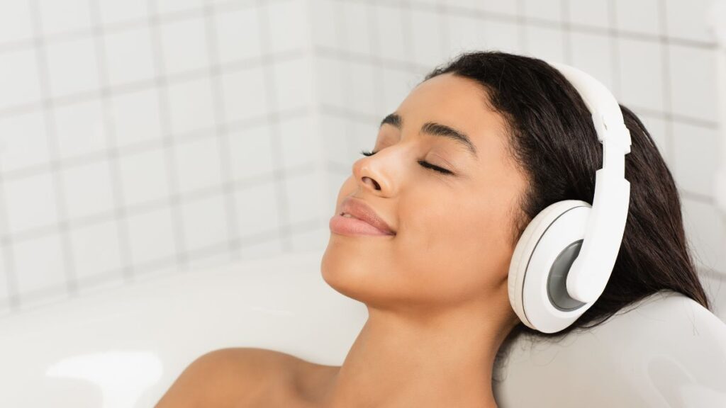 woman listening to music in bath