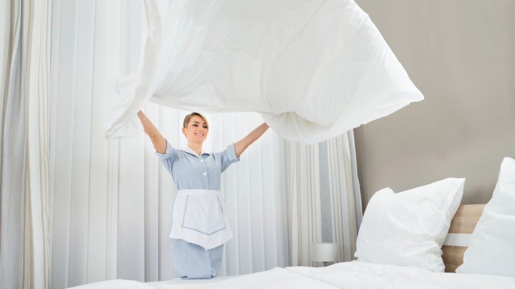 woman making hotel bed