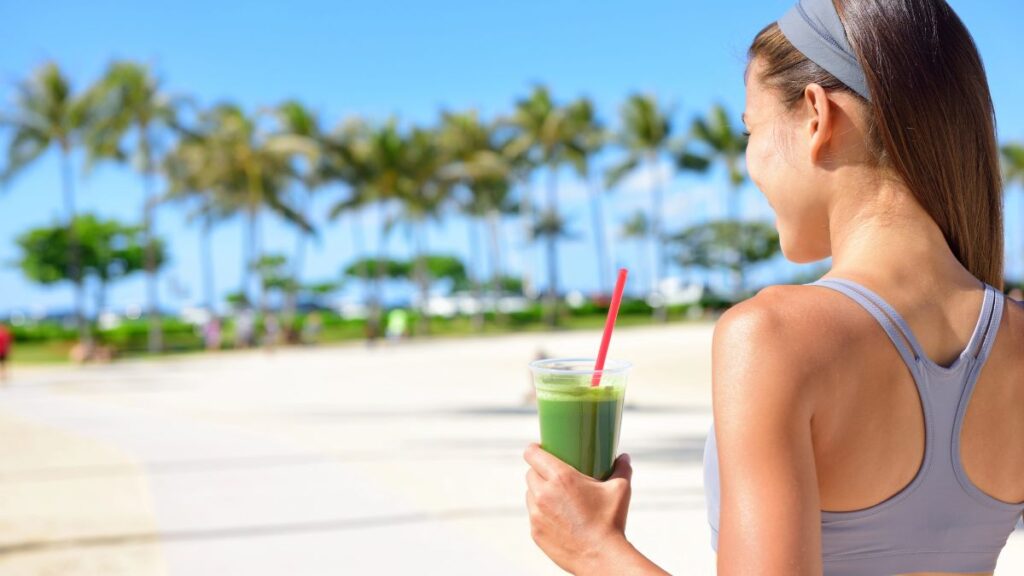 woman on beach with smoothie