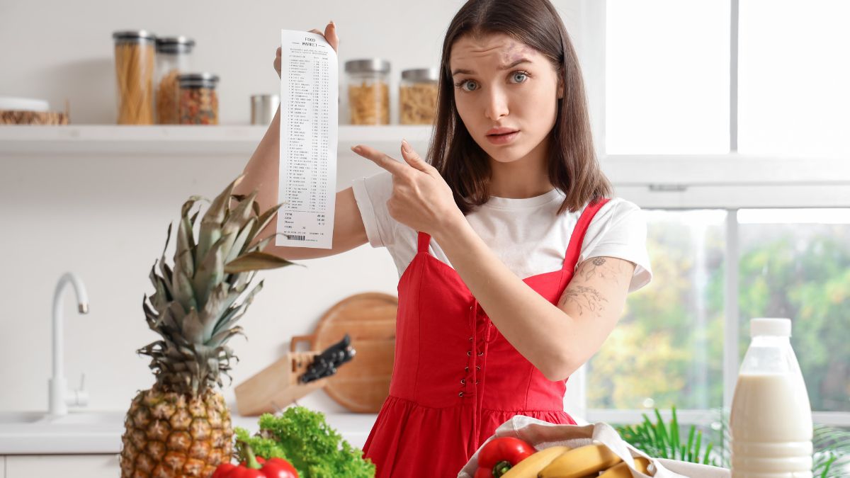 woman pointing to grocery receipt