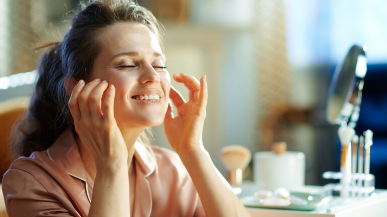 woman putting on face cream