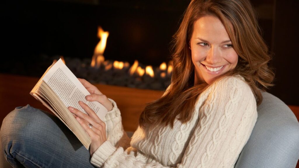 woman reading by fire