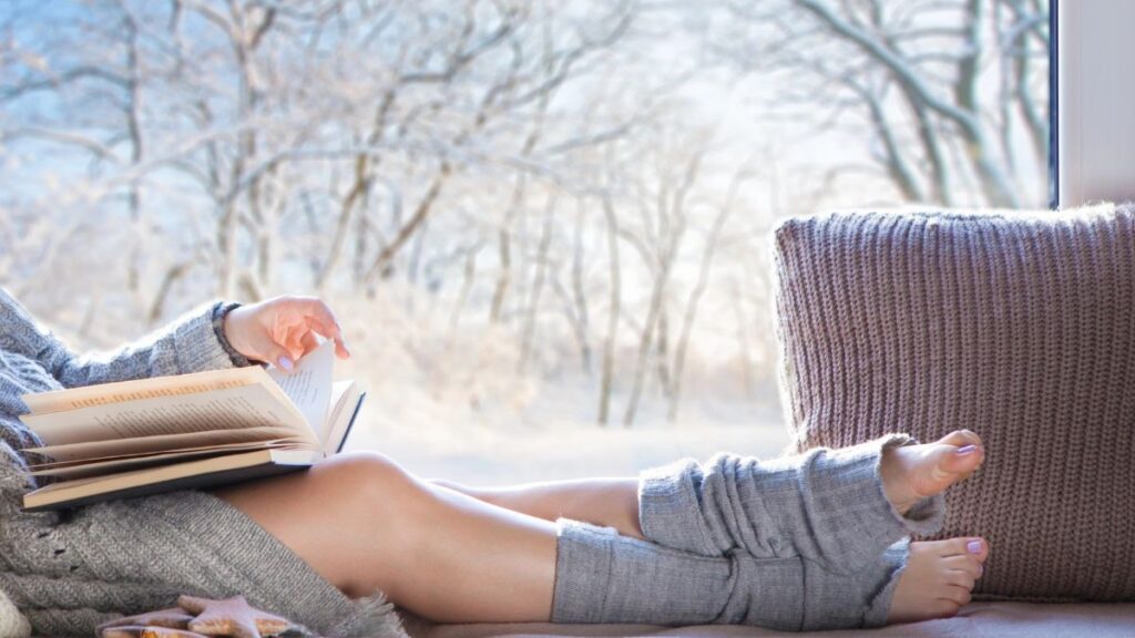 woman reading by window