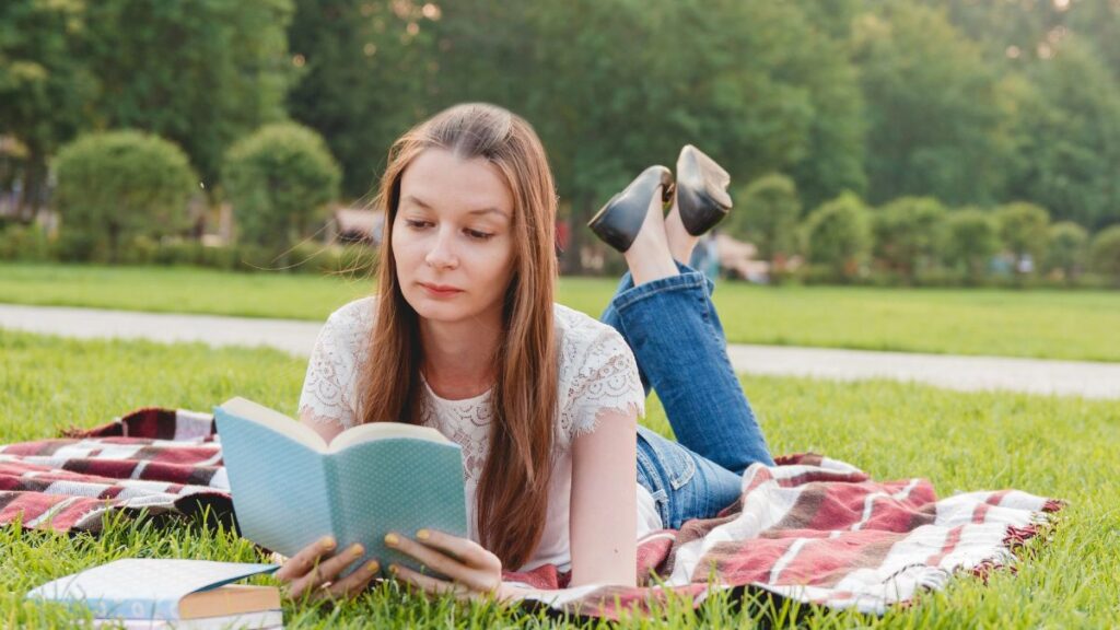 woman reading on grass