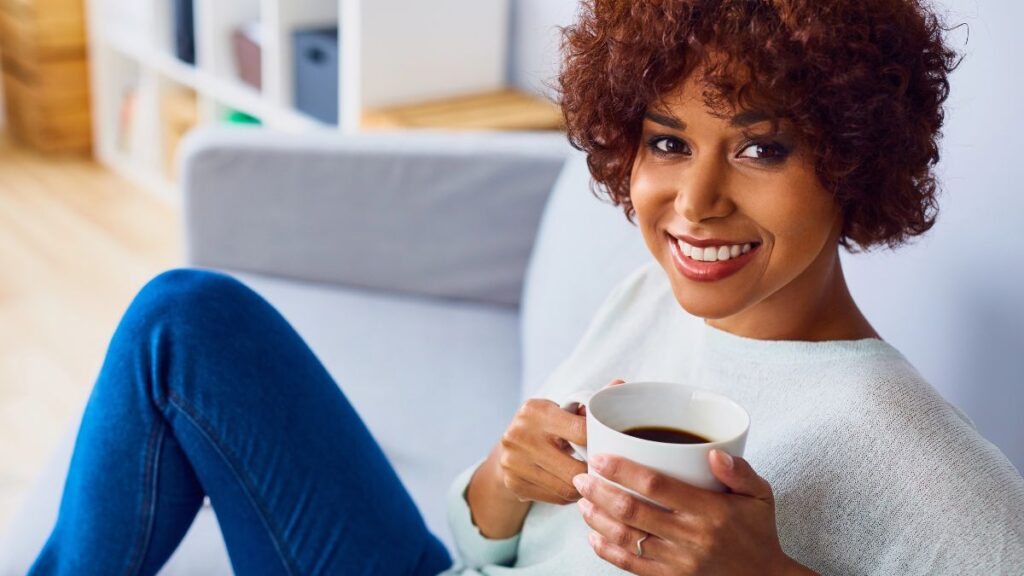 woman smiling with cup of coffee