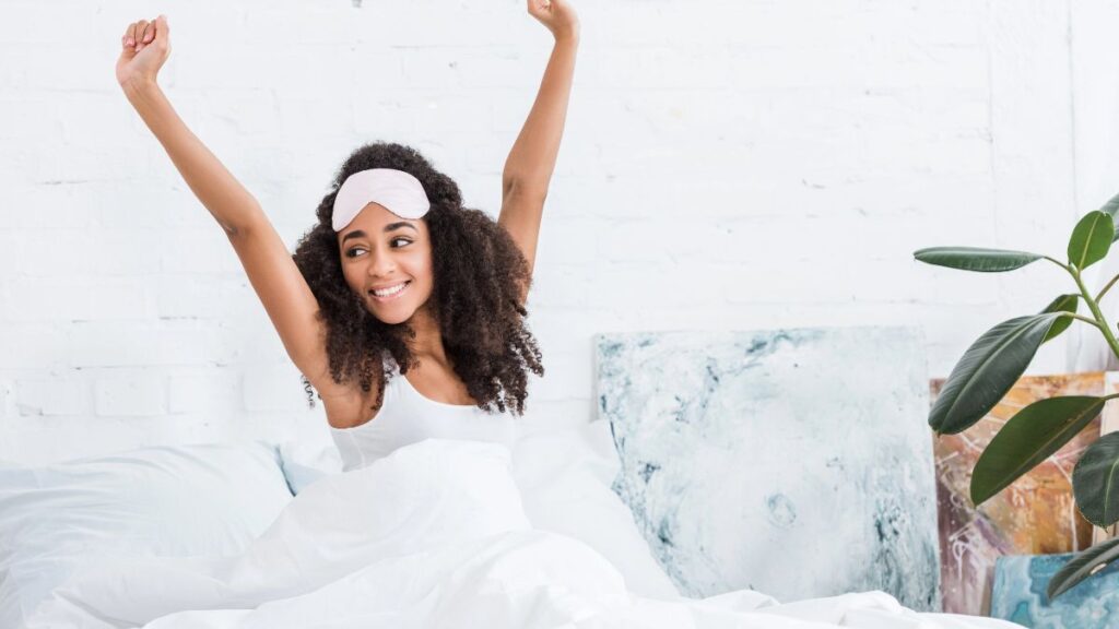 woman stretching in bed