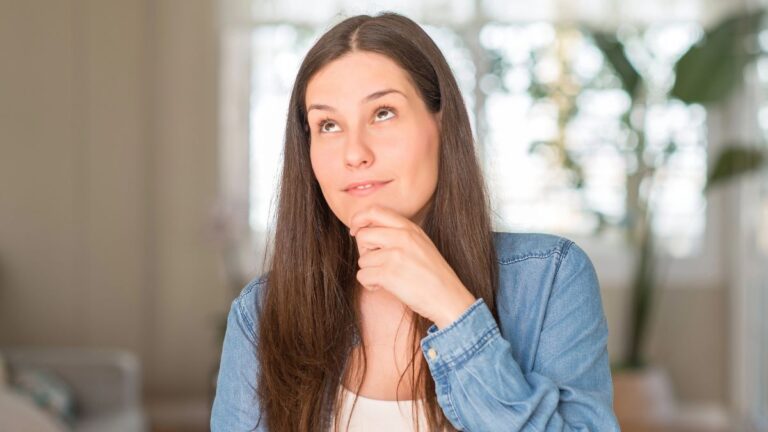 woman thinking with hand on chin