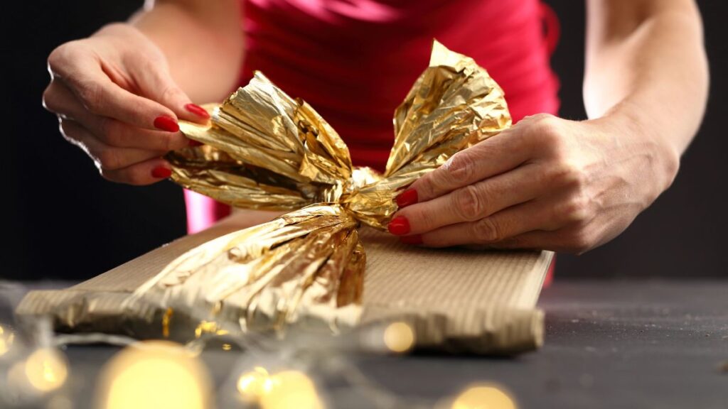 woman tying bow on gift