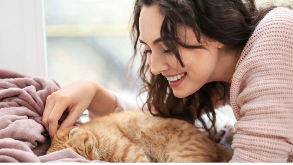 woman with cat on bed