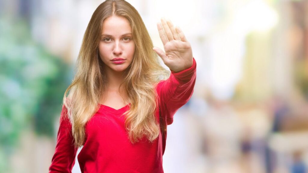 woman with hand up showing stop