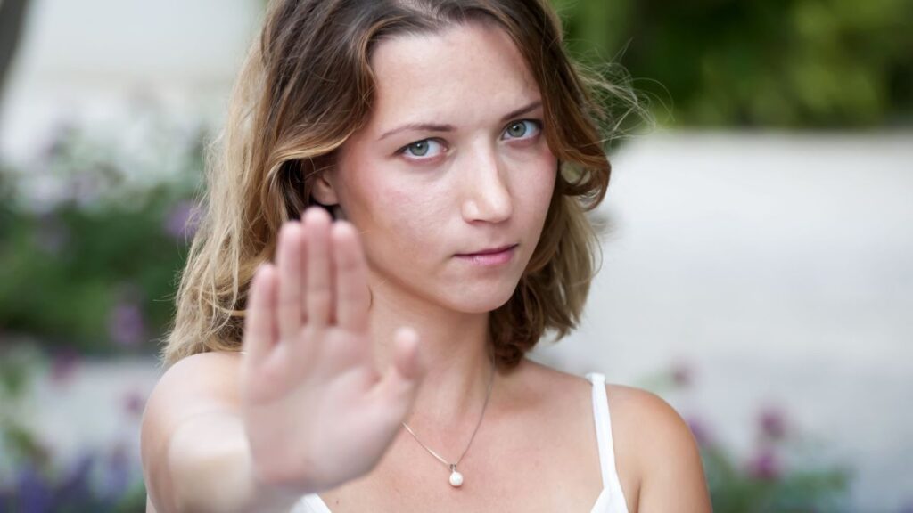 woman with hand up showing stop