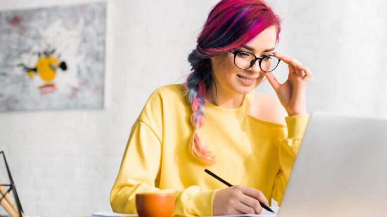 woman working on computer and writing