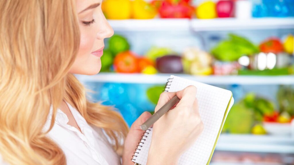 woman writing grocery list