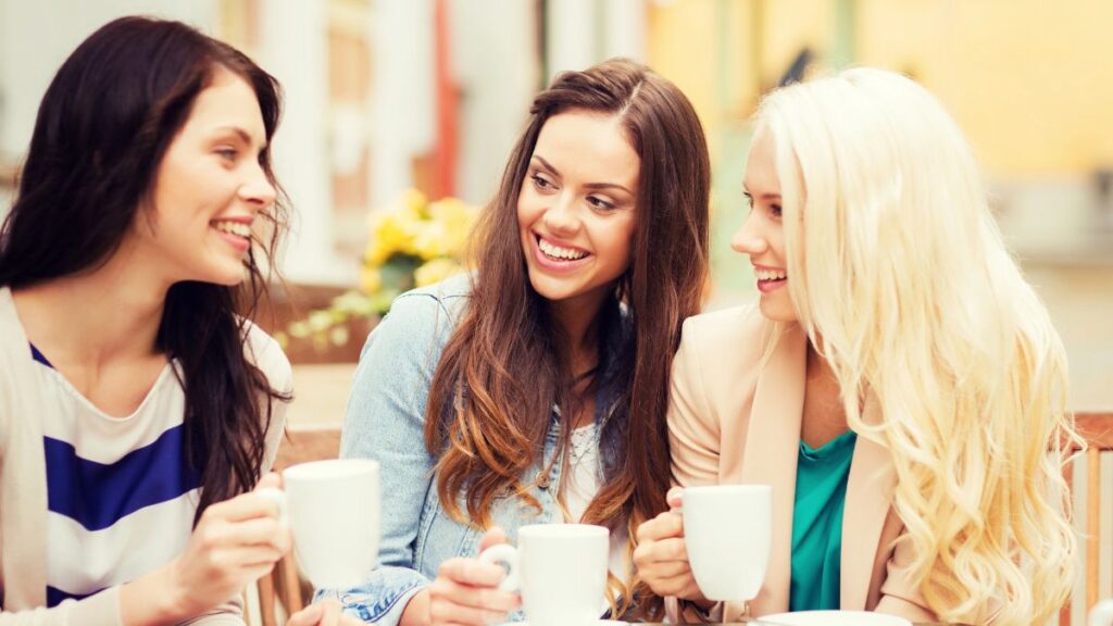 women talking with coffee